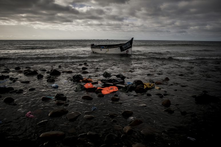 A boat used by migrants can be seen abandonded at a beach after their arrival.